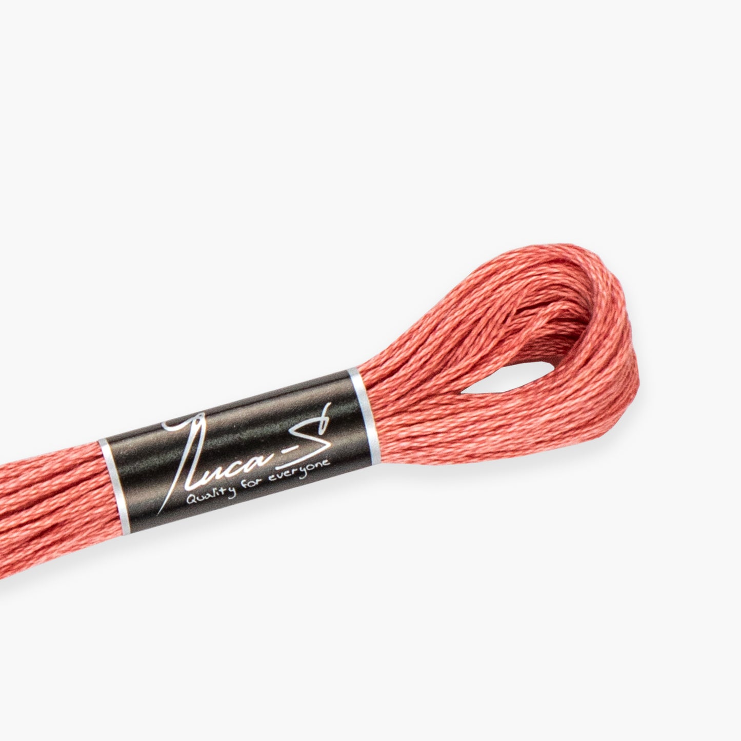 Skein of coral thread with 'Luca' label on a white background