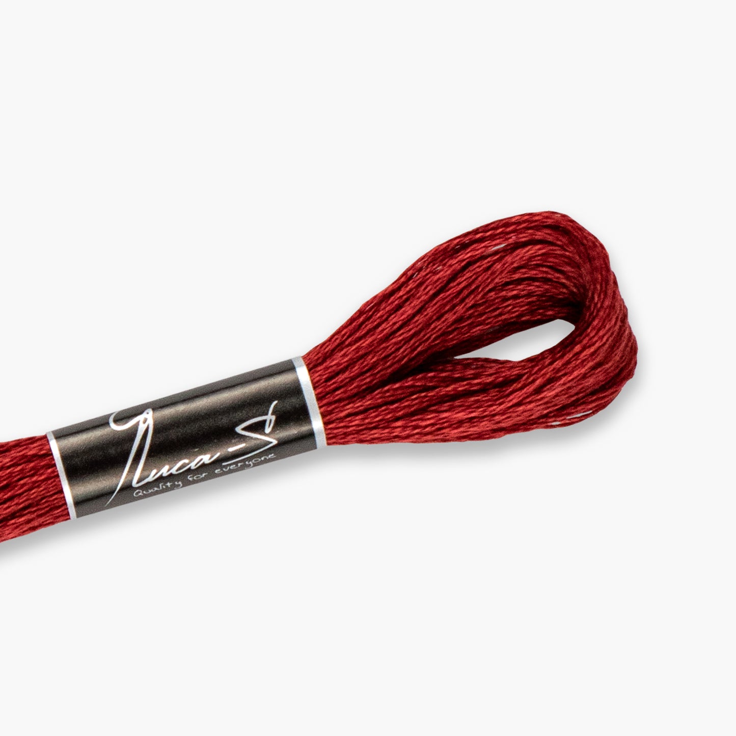 Red embroidery floss spool with a branded label on a white background