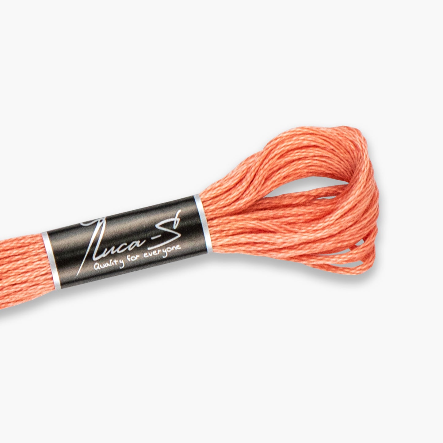 Stranded cotton of coral embroidery floss with 'Luca-S' label on a white background