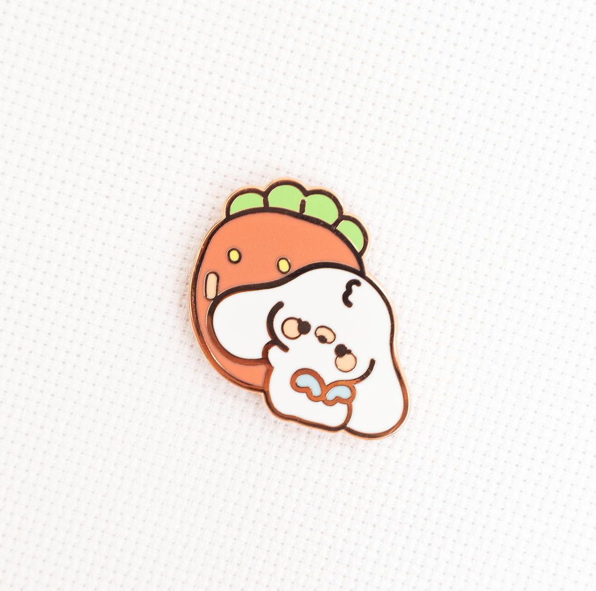 A cute cartoon enamel pin featuring a white dog character with a carrot-shaped head on a textured white background.