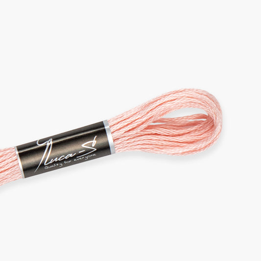 Spool of pink embroidery floss with 'Luca-S' label on a white background