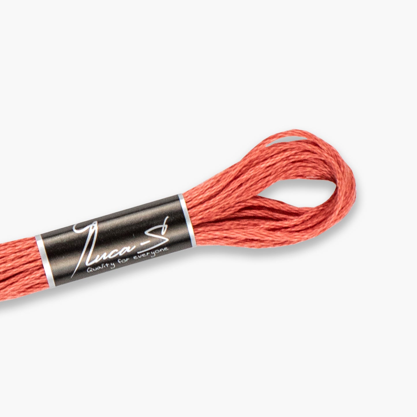Stranded cotton of coral embroidery floss with a Luca-S label on a white background