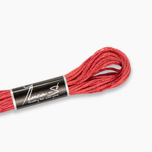 Red embroidery floss spool with a black label on a white background