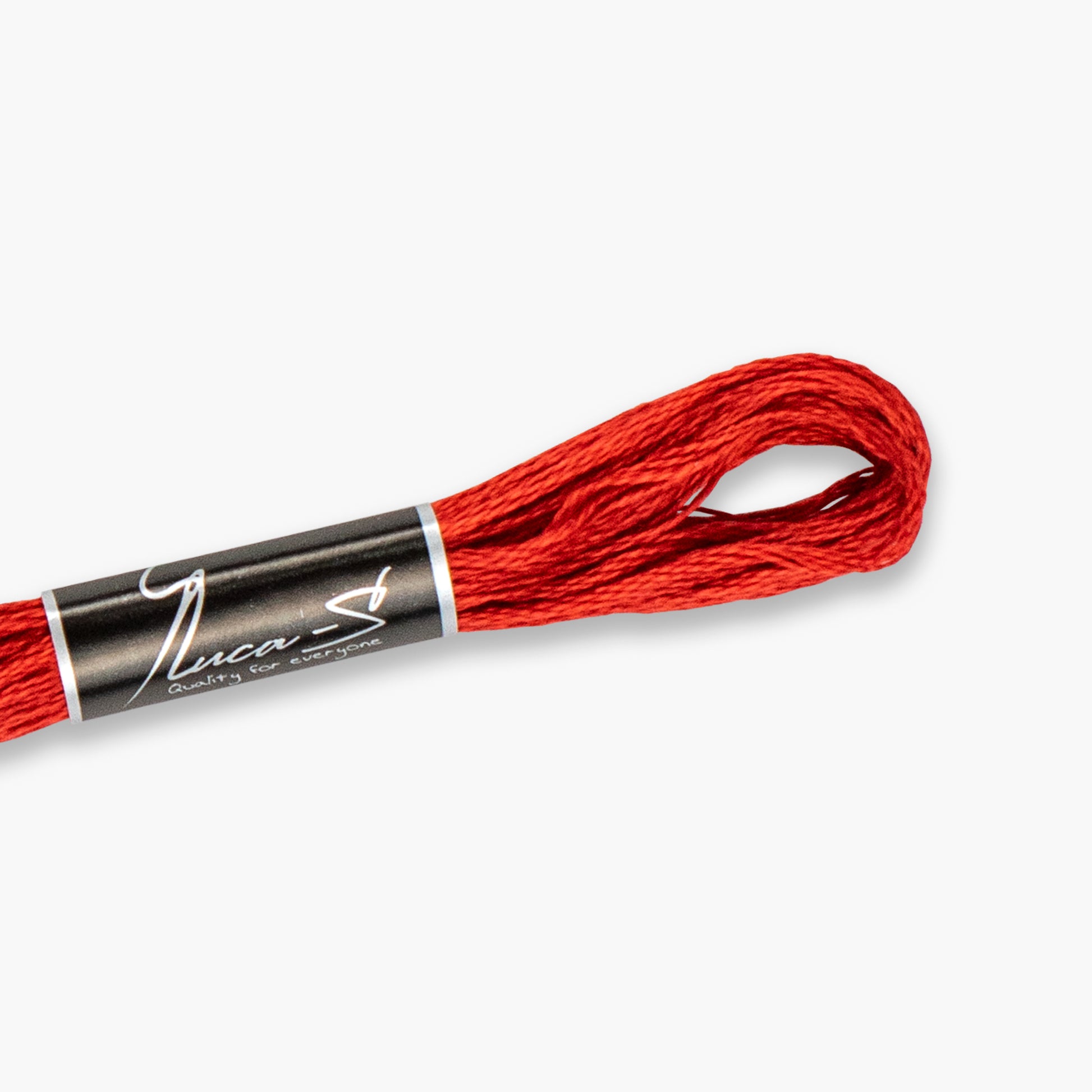 Red embroidery floss spool with a black label on a white background