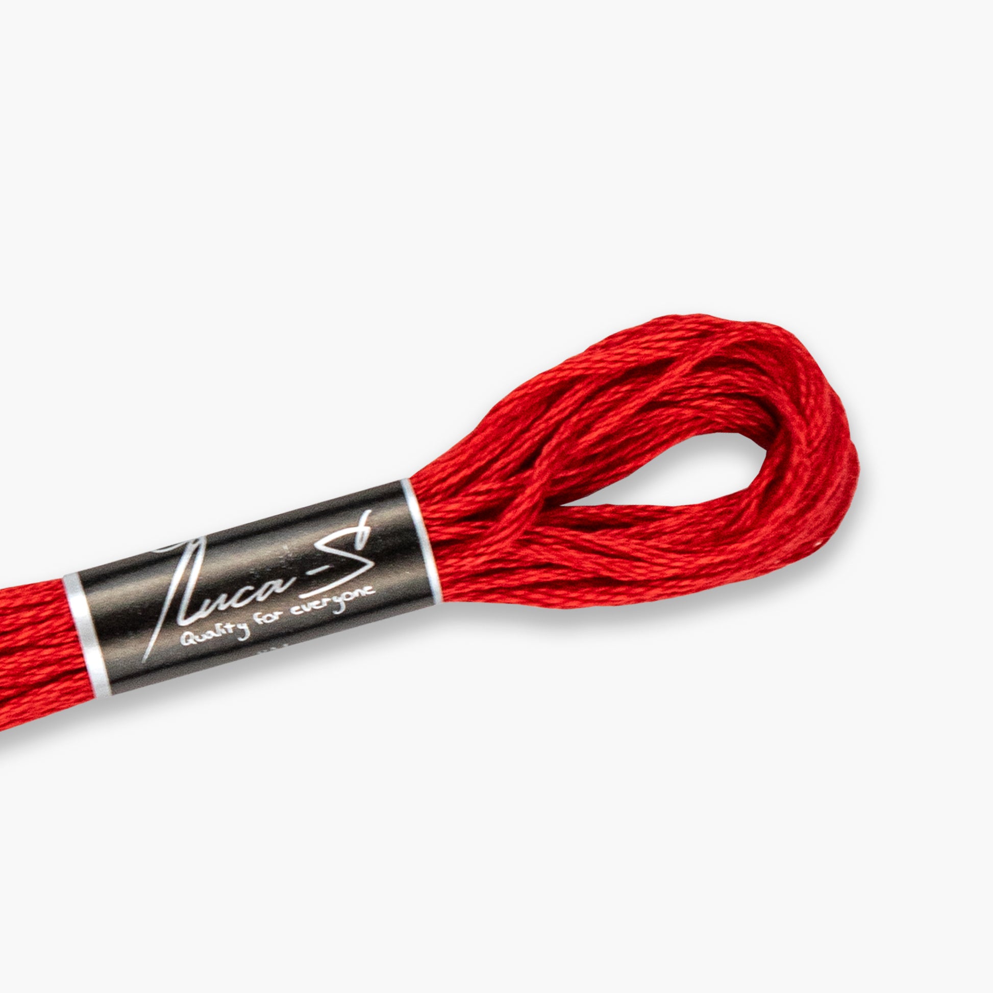 Red embroidery floss spool with 'Nusca' label on a white background