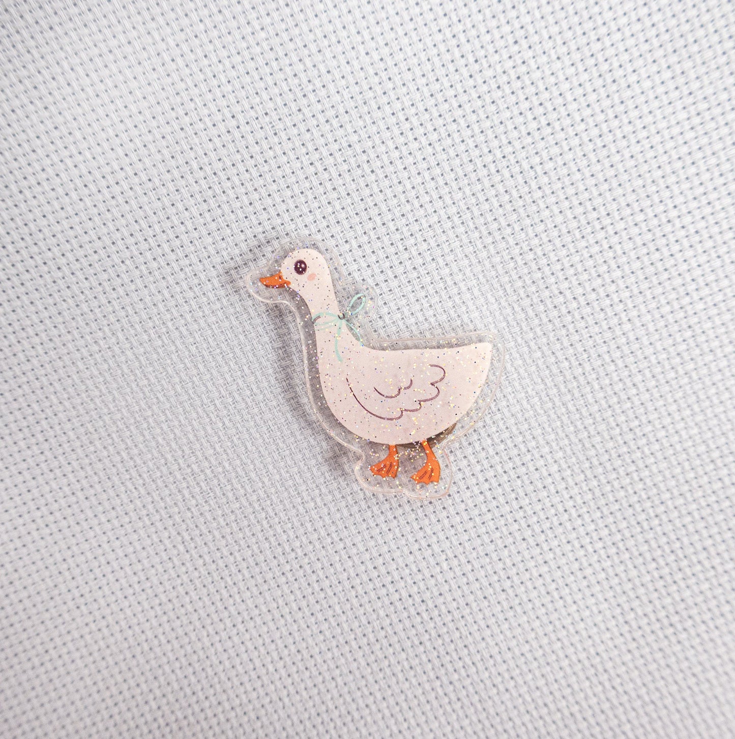 Small duck magnet on a textured light gray background