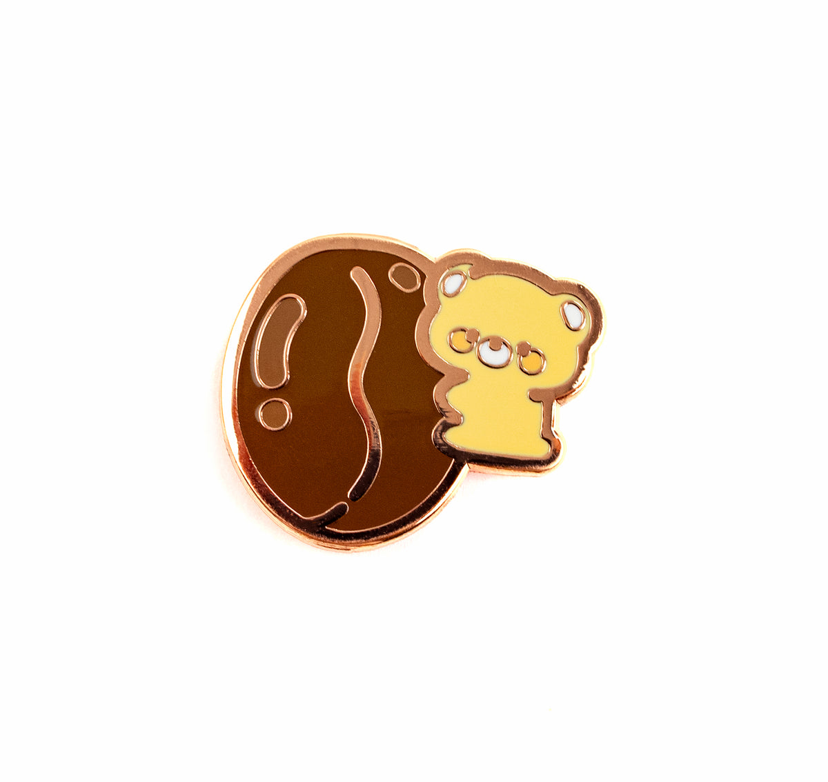 A cute enamel pin featuring a yellow cartoon bear peeking out from behind a large brown nut shell, set against a plain white background.