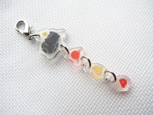 Decorative scissor minder with colorful beads and a clip on a white background