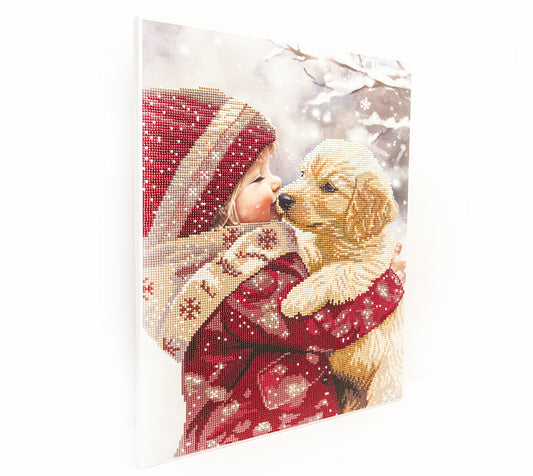 Diamond art Club, diamond Painting design of a child in a red outfit with a dog, set against a snowy background.