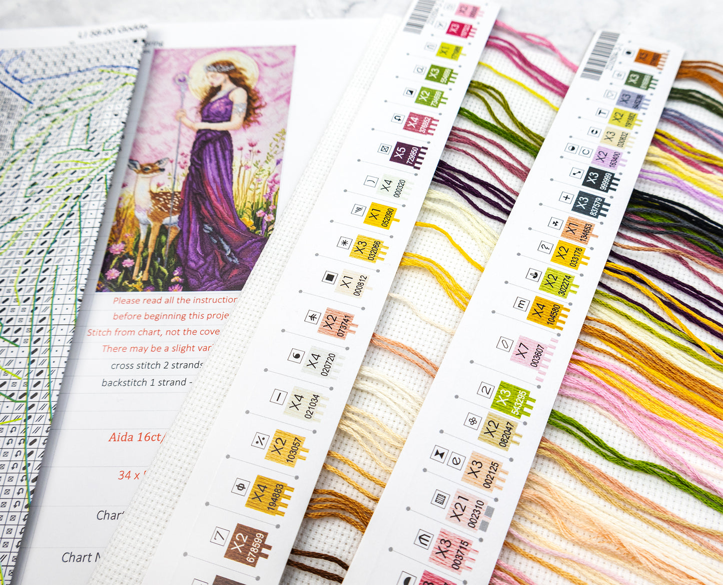 Cross-stitch chart with colorful thread samples and design illustration