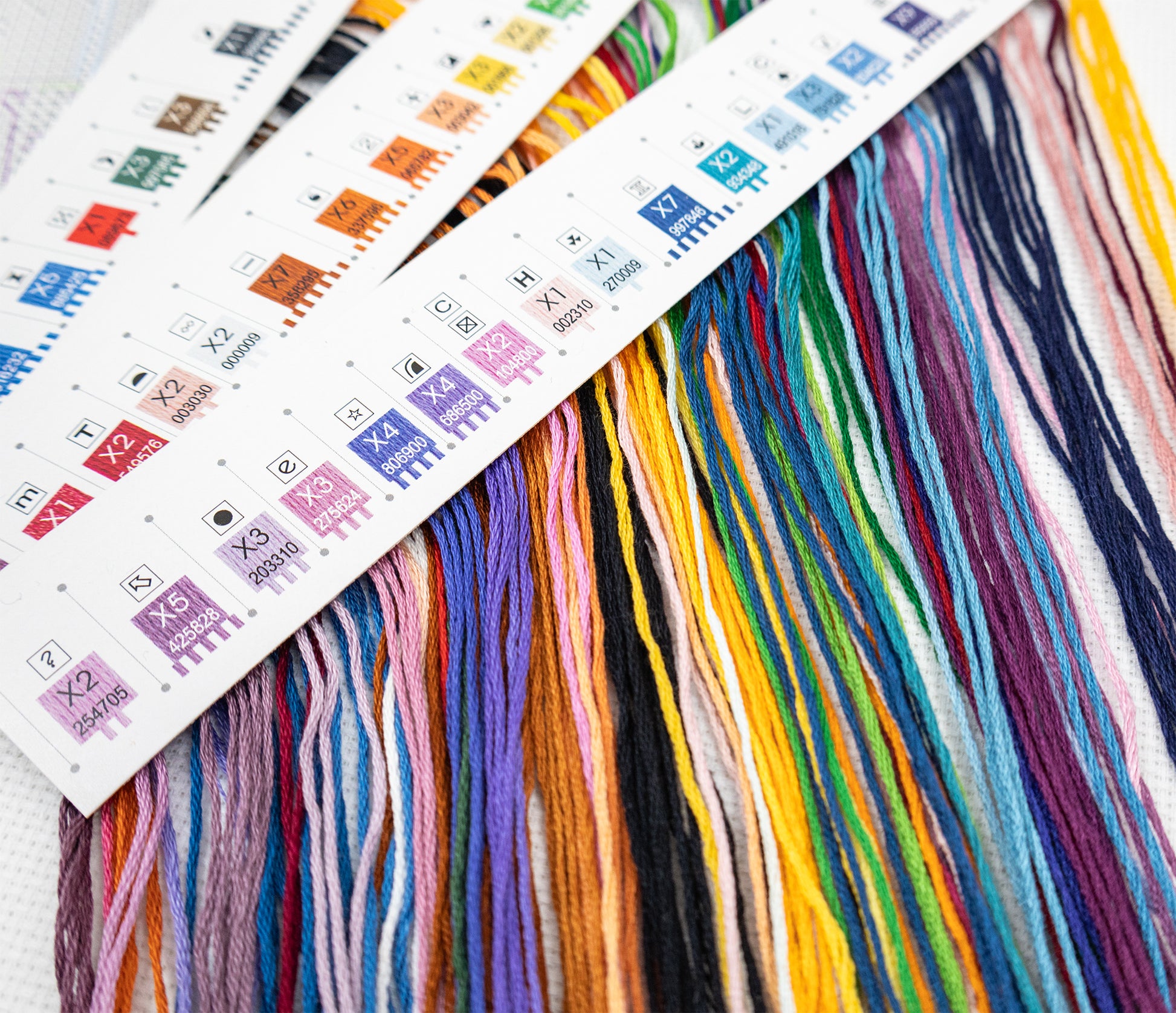 Color swatches with embroidery floss and color chart on a white background