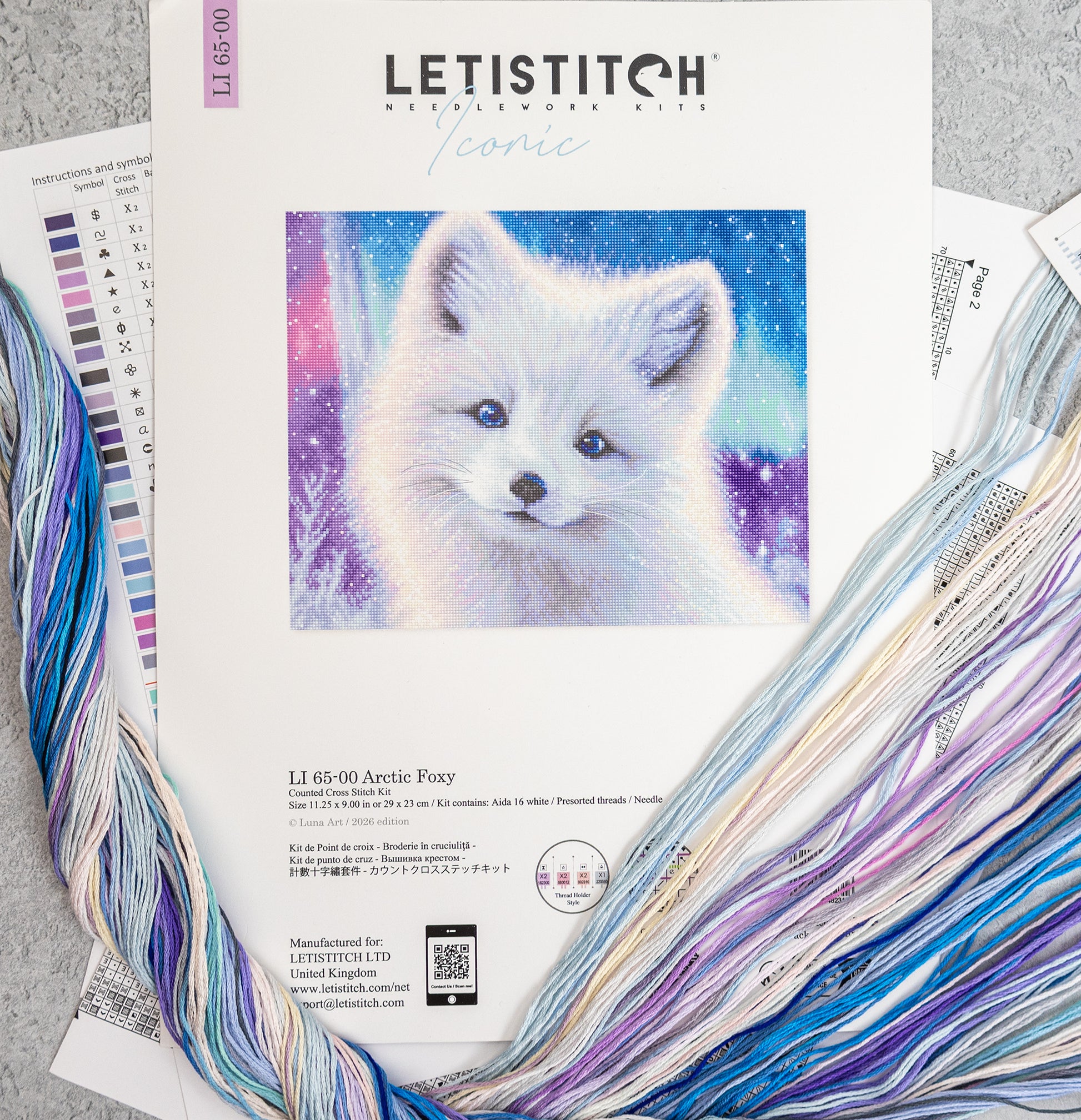 Letistitch embroidery kit with arctic fox design and colorful threads on a gray surface