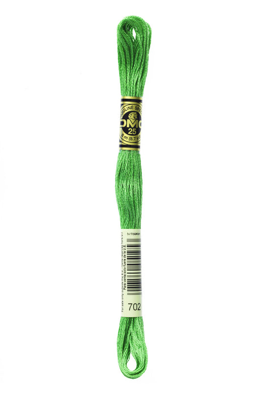 Green embroidery floss spool with a label on a white background