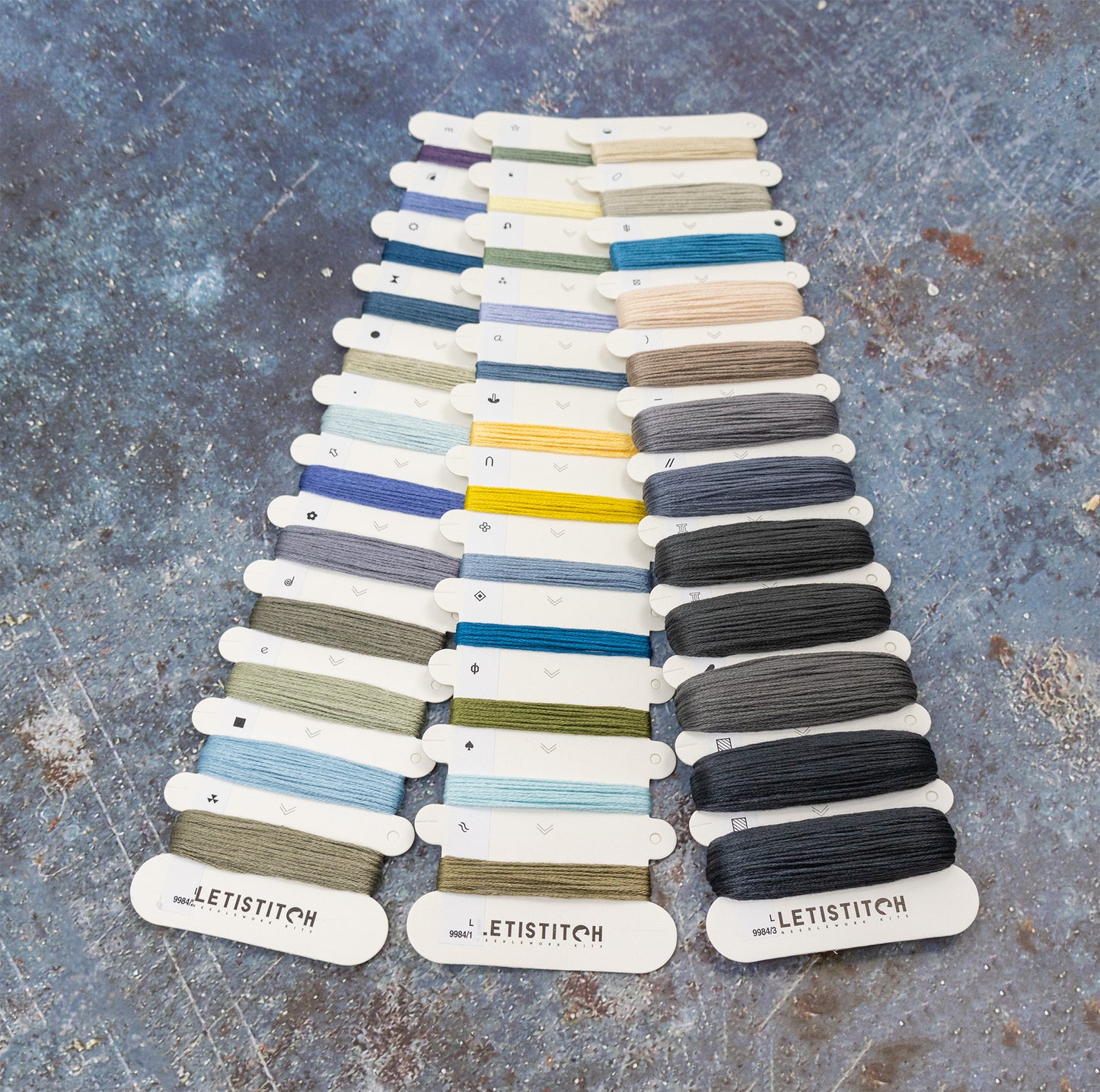 Color card with various thread colors on a textured surface