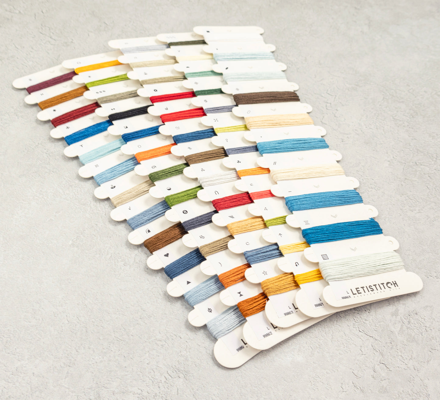 Color swatch card with embroidery threads on a gray background