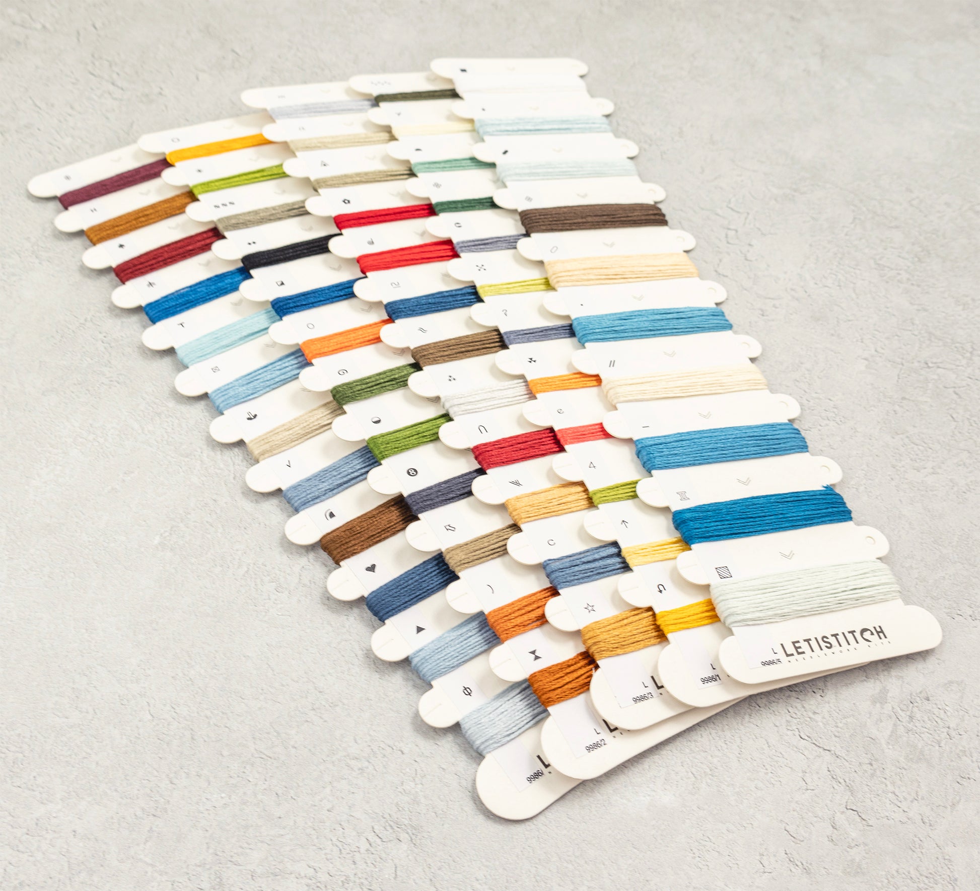 Color swatch card with embroidery threads on a gray background