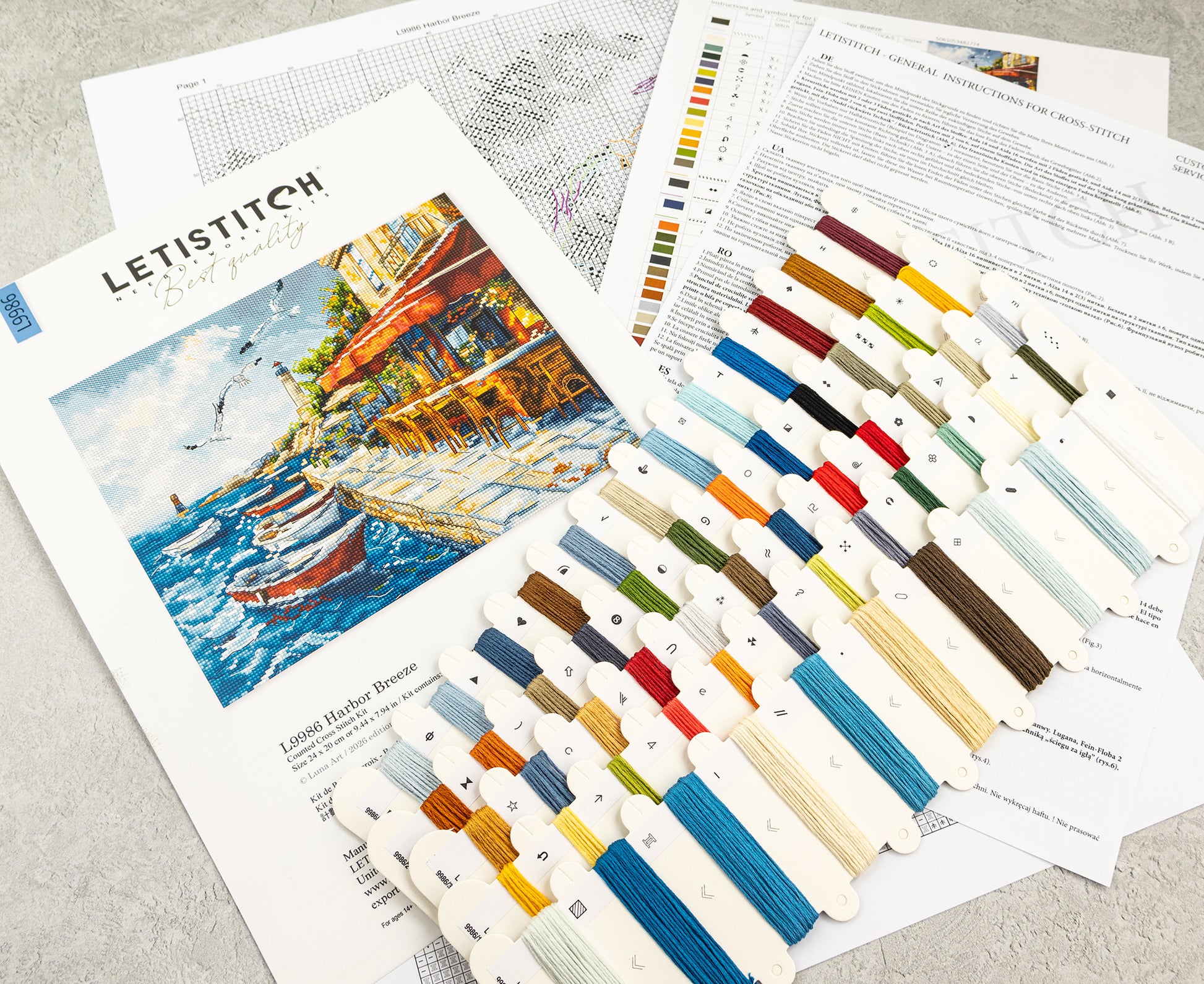 Embroidery thread set with color swatches and a painting of a harbor scene.