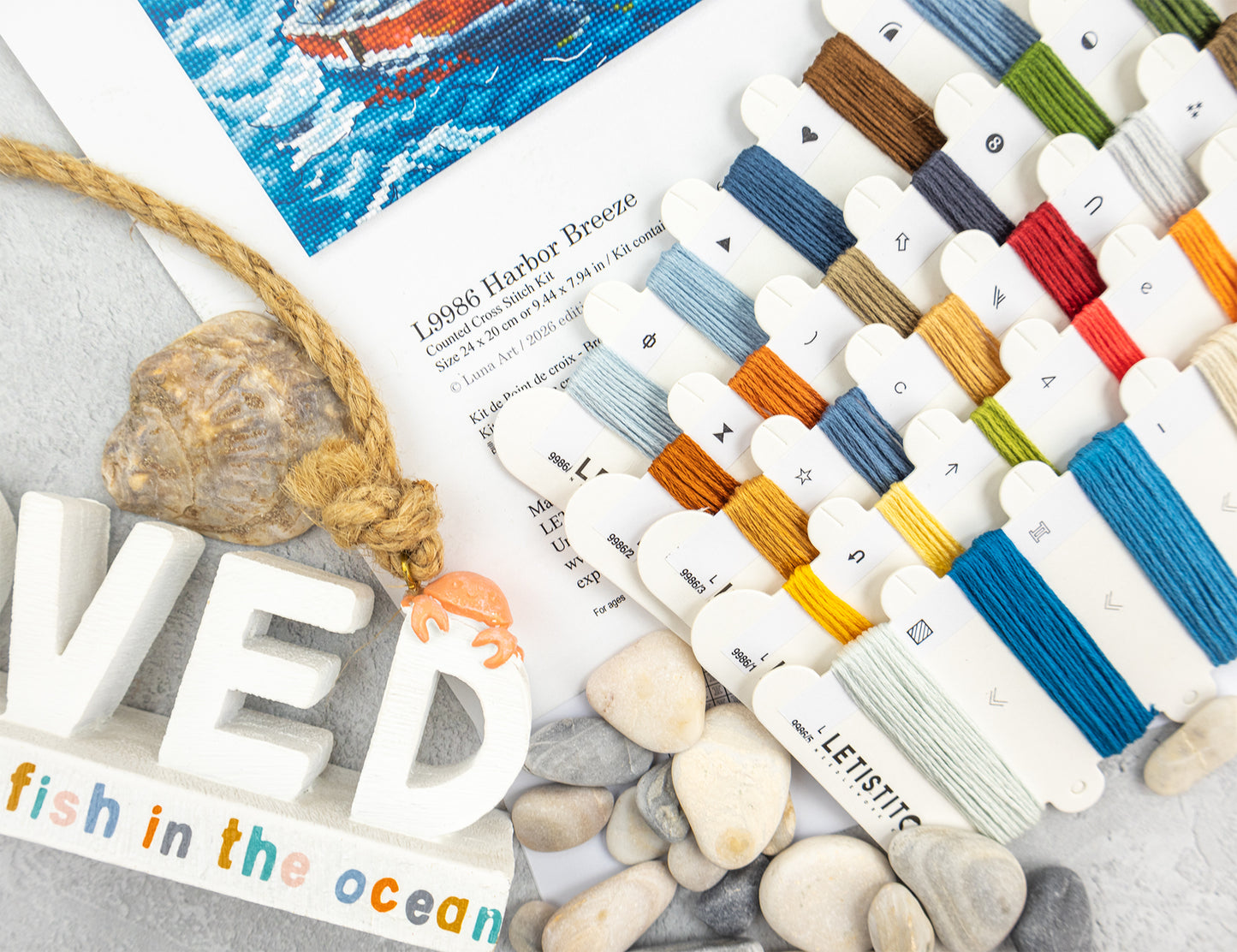 Color swatches with yarn samples on a textured surface with 'fish in the ocean' text.