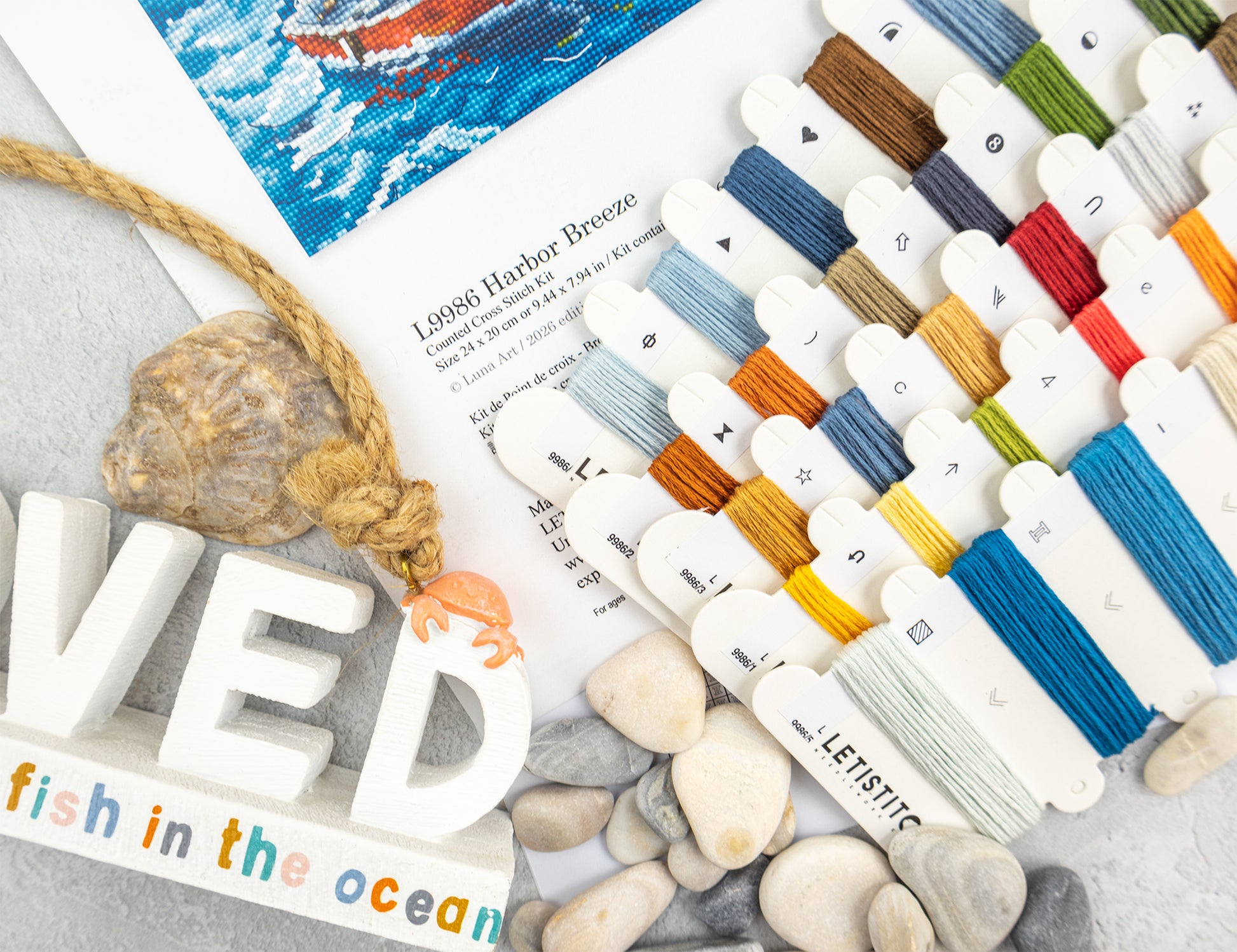 Color swatches with yarn samples on a textured surface with 'fish in the ocean' text.