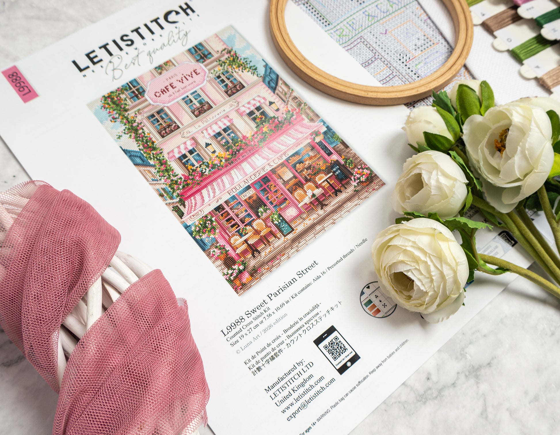 Letistitch craft magazine with embroidery hoop and flowers on a marble surface