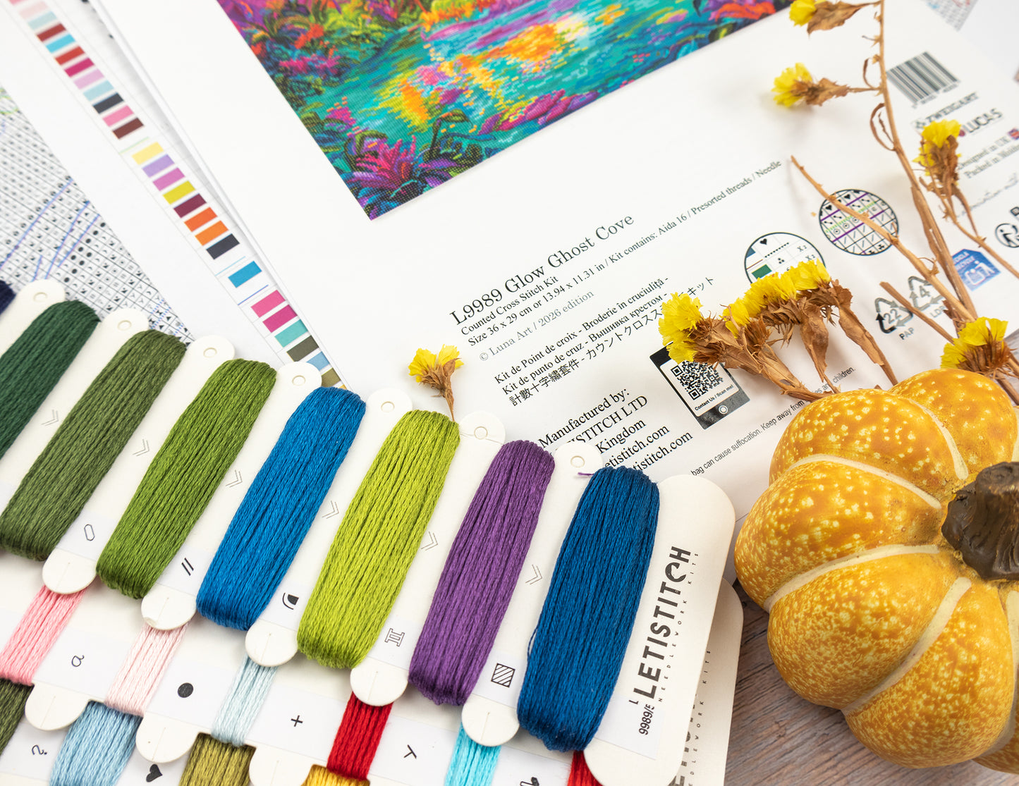 Color swatches with embroidery floss and a decorative pumpkin on a magazine page.