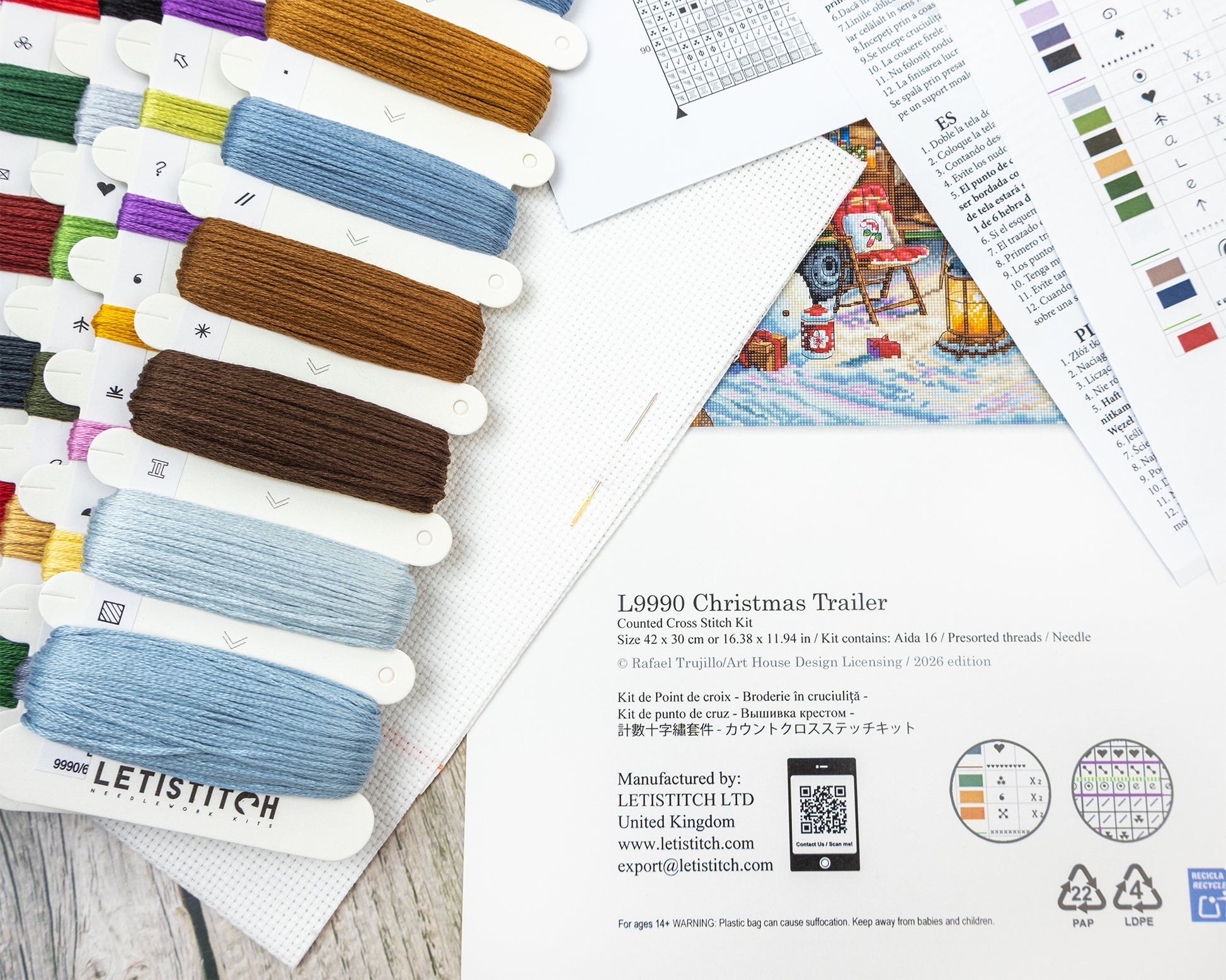 Embroidery thread set with color swatches and pattern sheets on a wooden surface