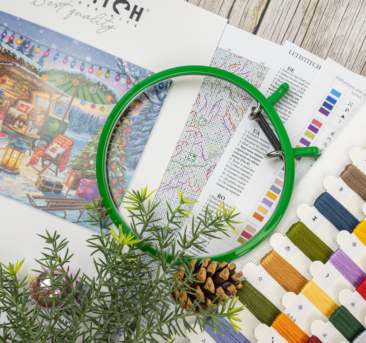 Embroidery hoop on a fabric with thread colors and design reference book