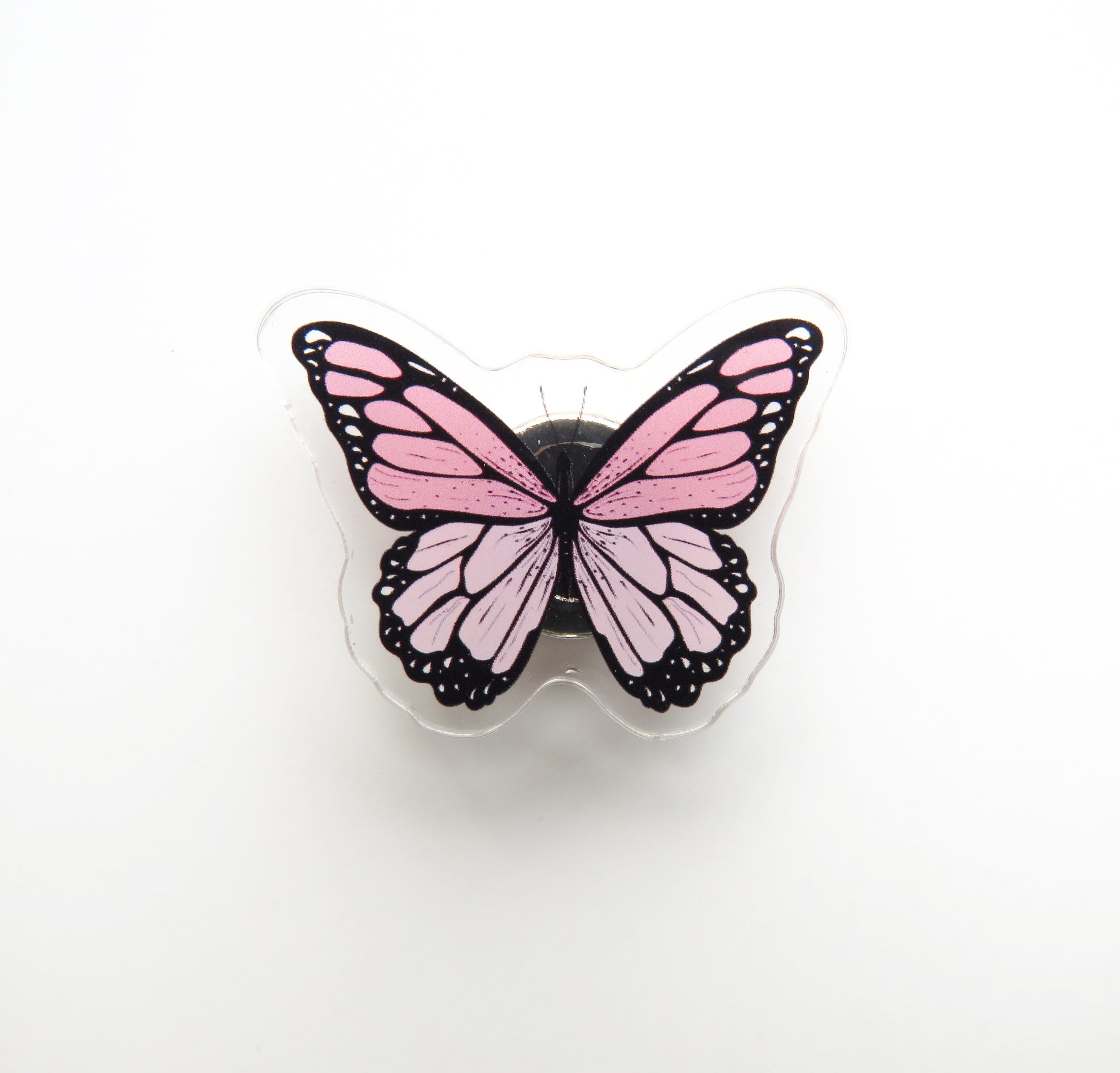 Pink butterfly-shaped needleminder on a white background