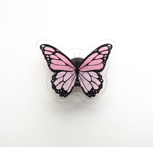 Pink butterfly-shaped needleminder on a white background