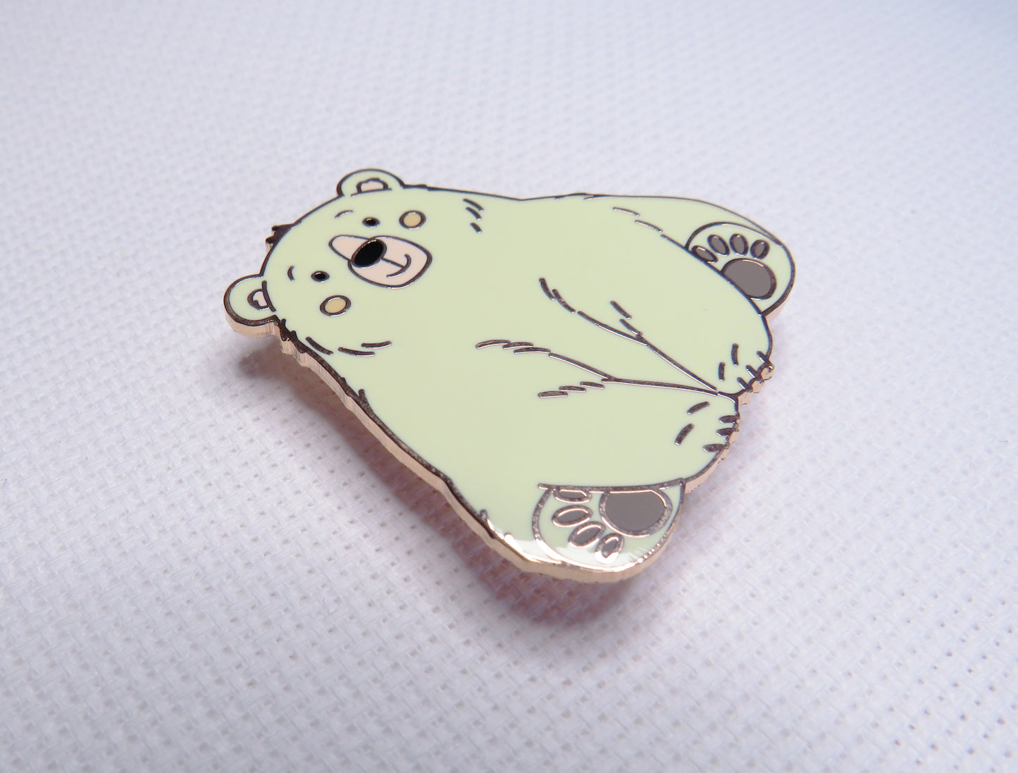 beige bear-shaped needleminder on a light gray background