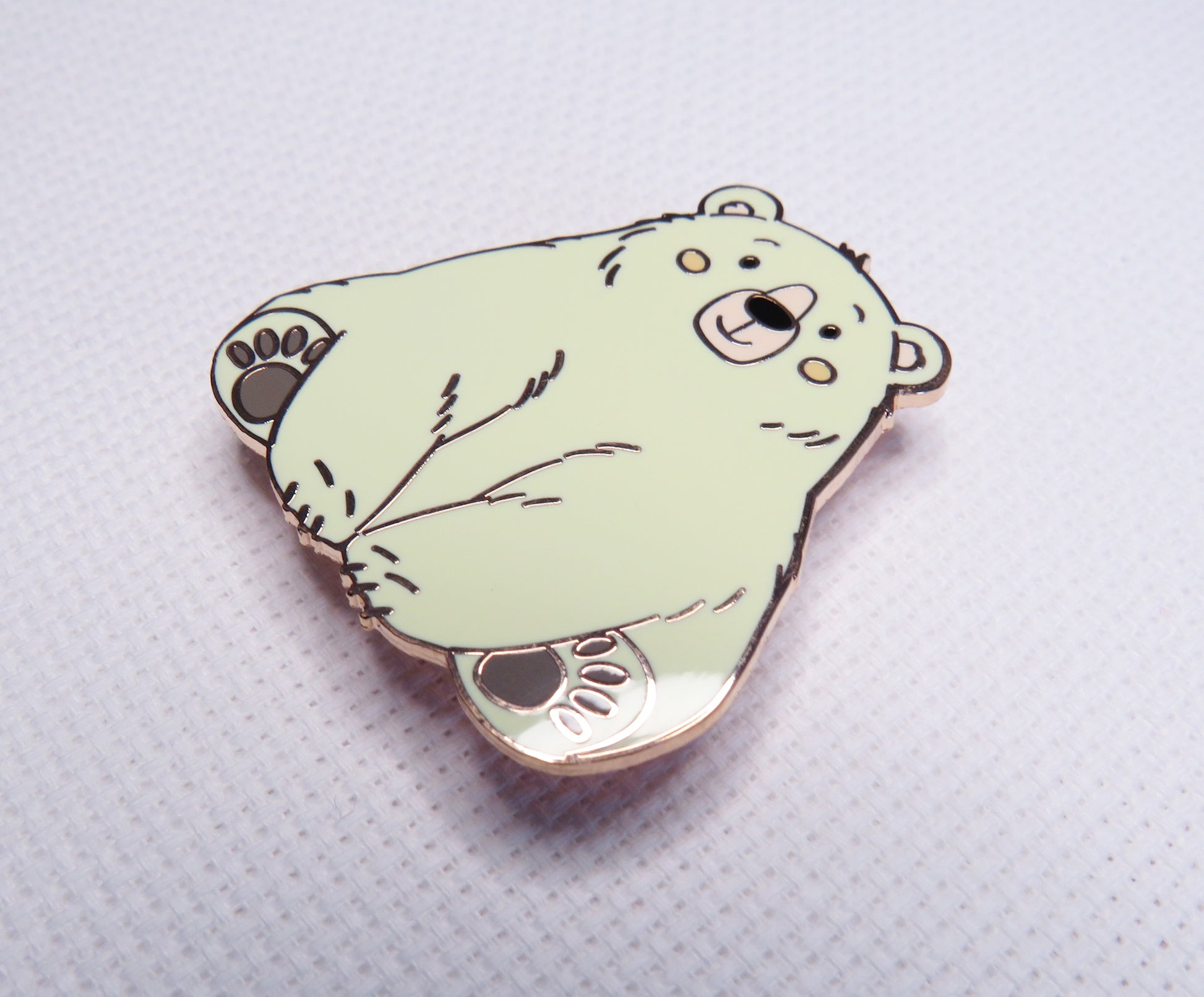 Cartoon bear needleminder on a textured white background