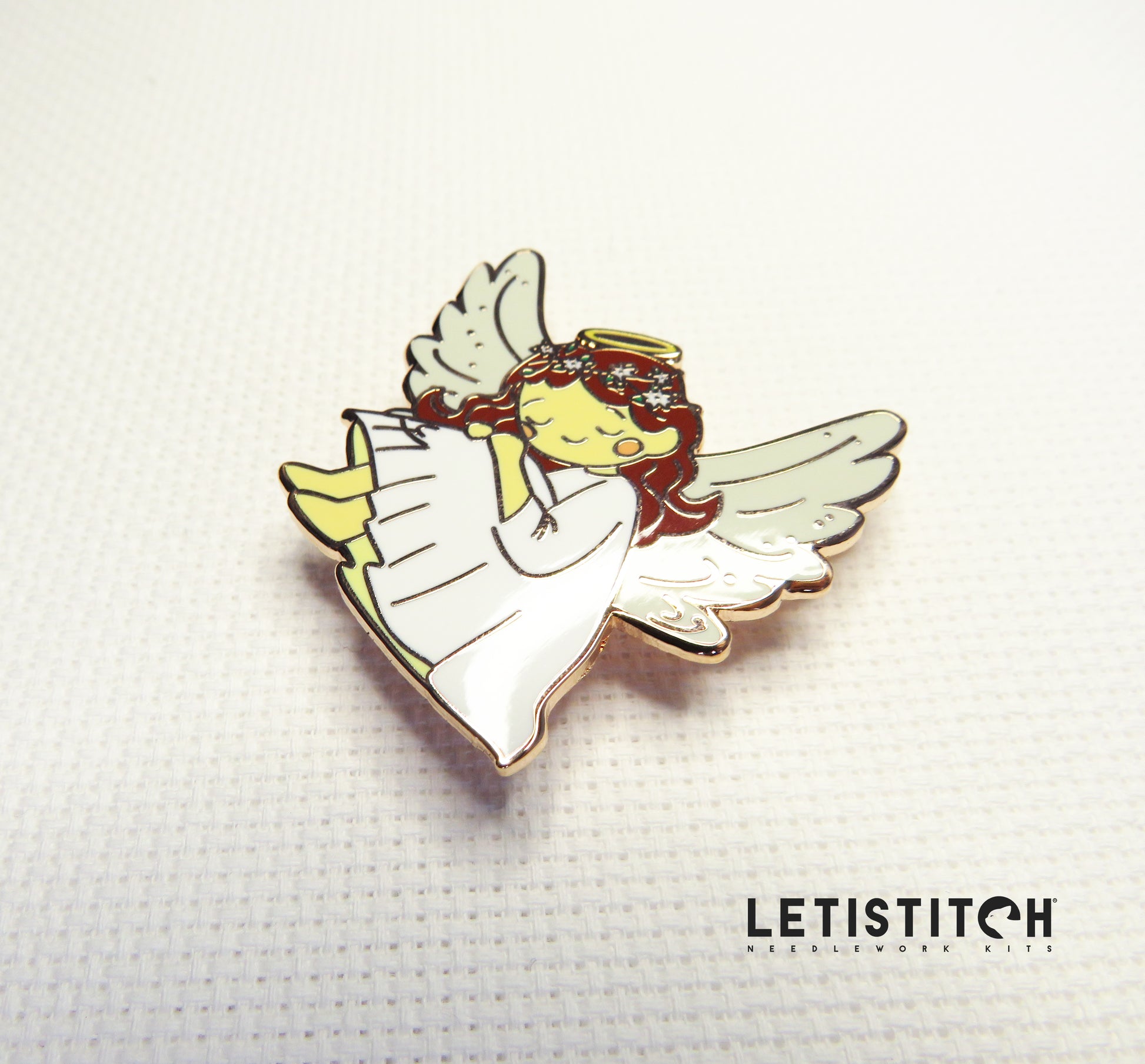Angel-shaped needleminder with wings on a textured white background, featuring the brand 'Letistitch'.