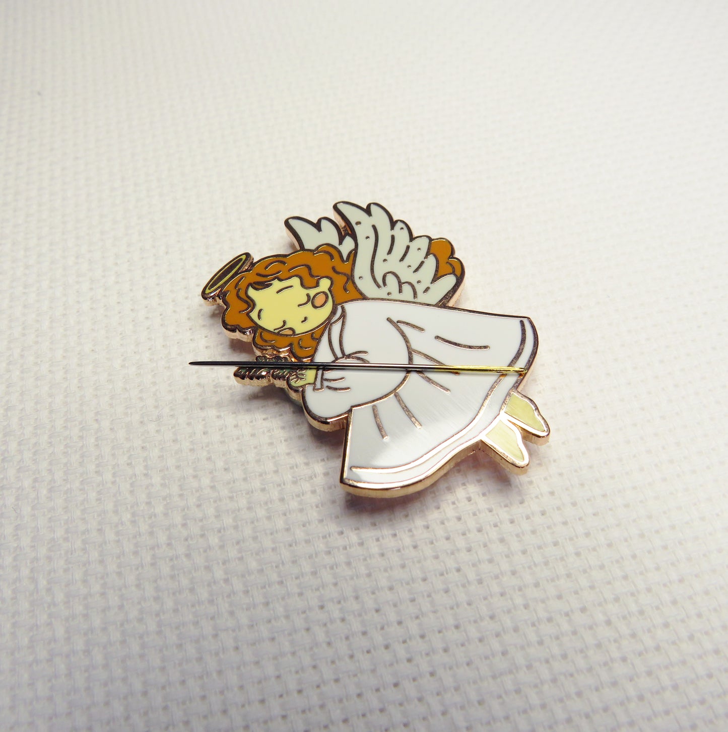 Angel needleminder on a textured white background