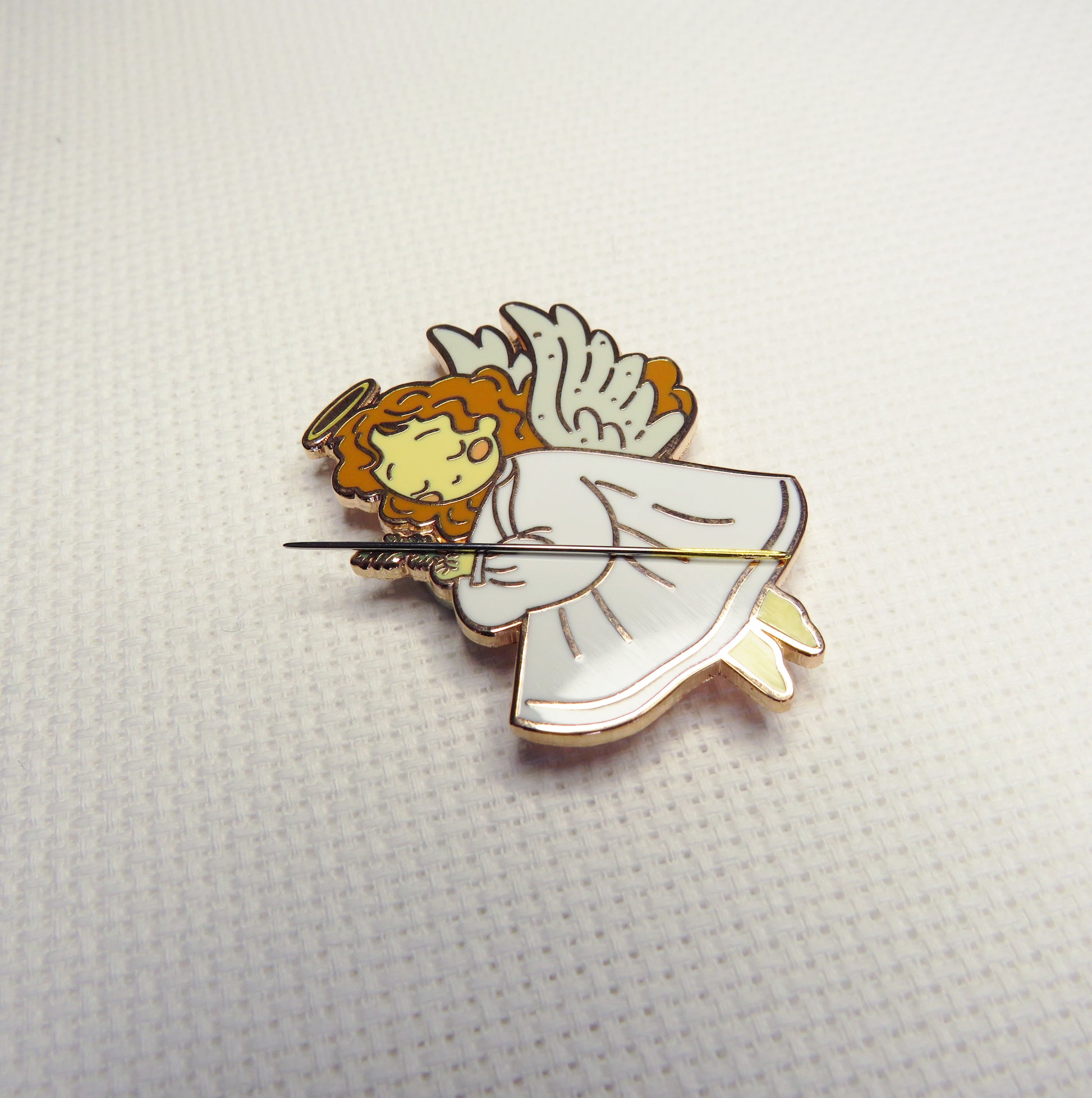 Angel needleminder on a textured white background