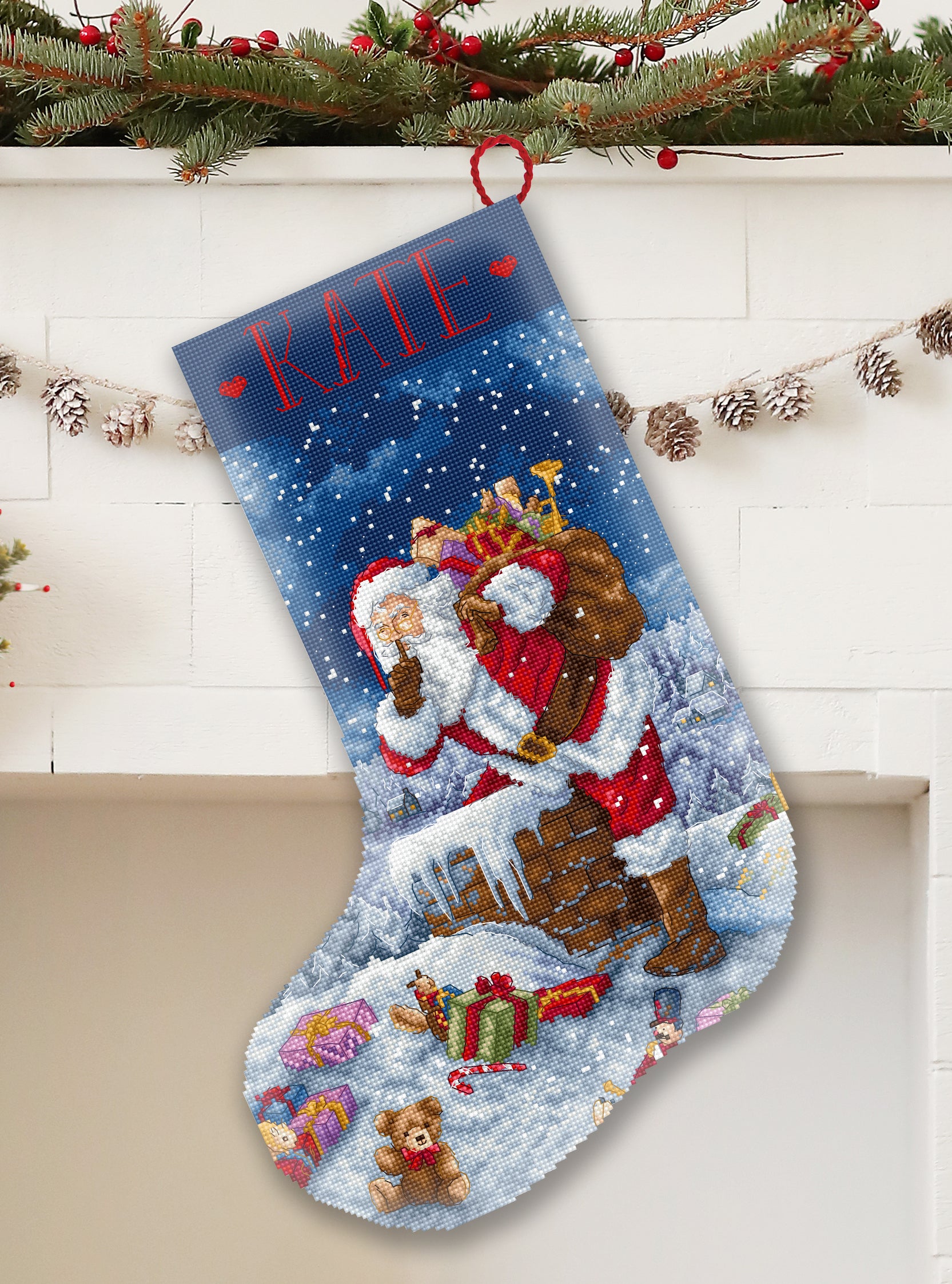 Christmas stocking with Santa Claus and teddy bears, personalized with 'KATE', on a decorative background.