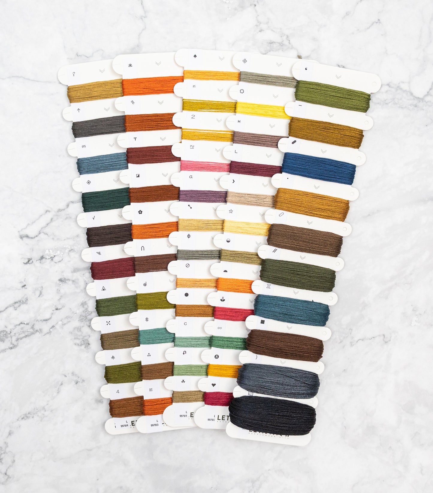 Set of colorful thread spools on a white background