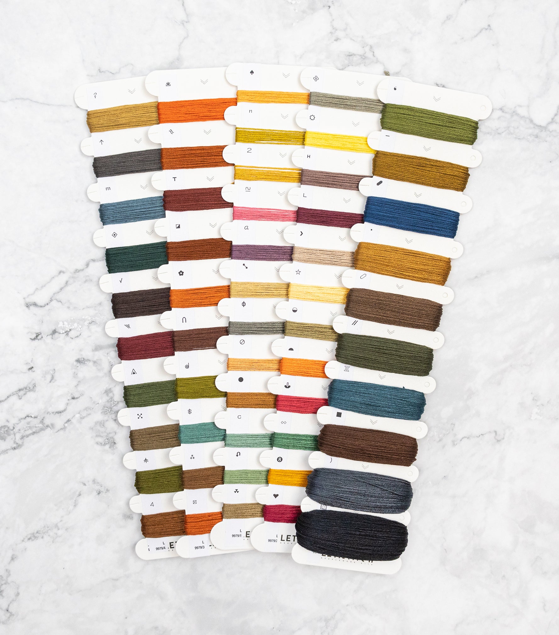 Set of colorful thread spools on a white background