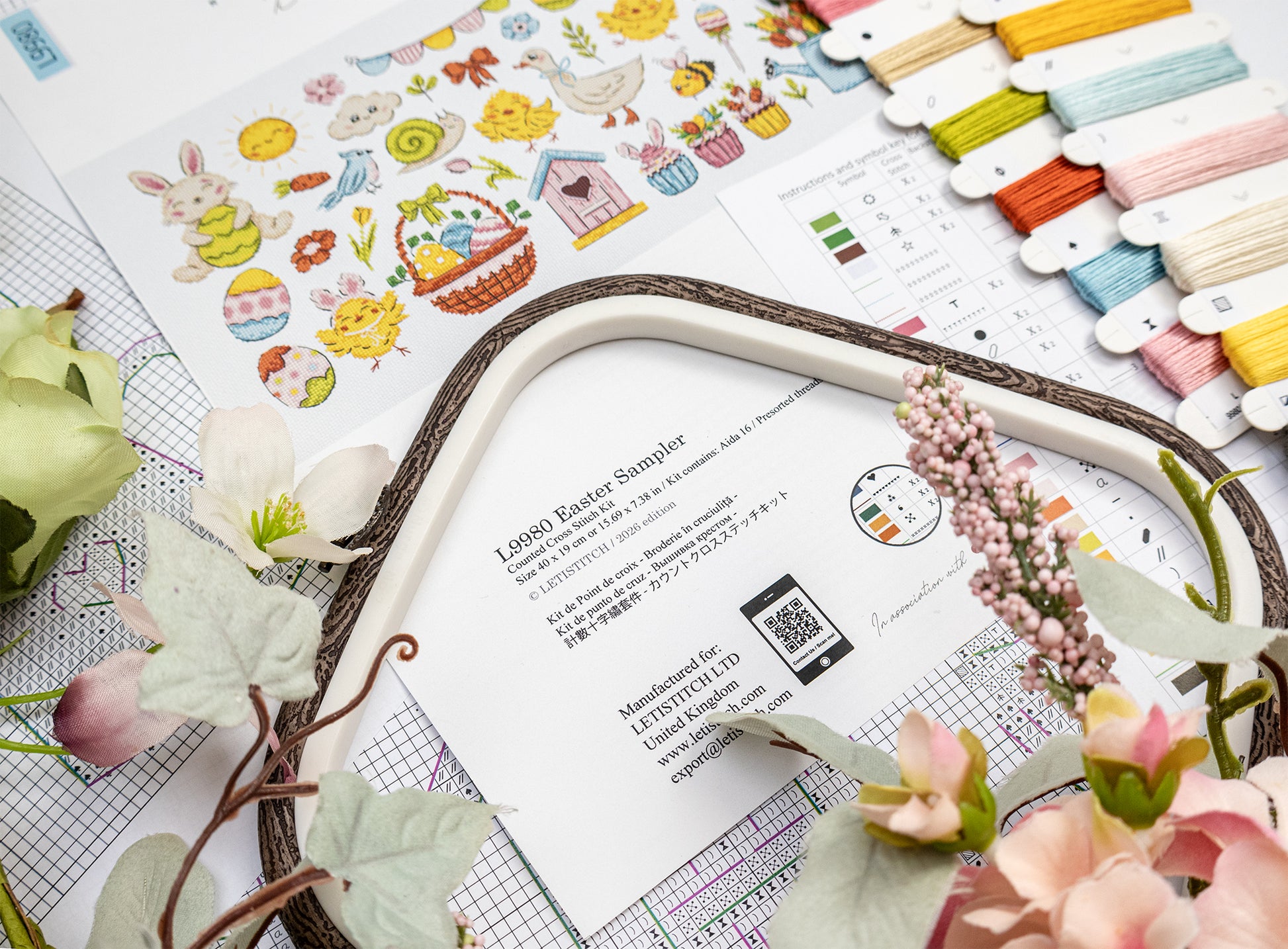 Decorative frame with floral elements on a table with stationery items.