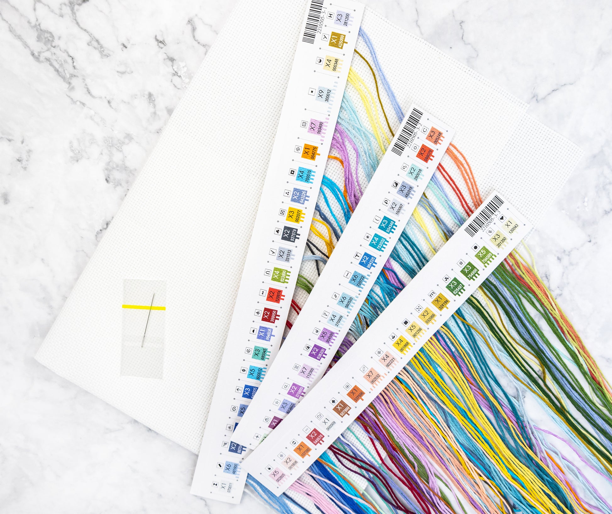 Color swatch cards with colorful patterns on a marble surface