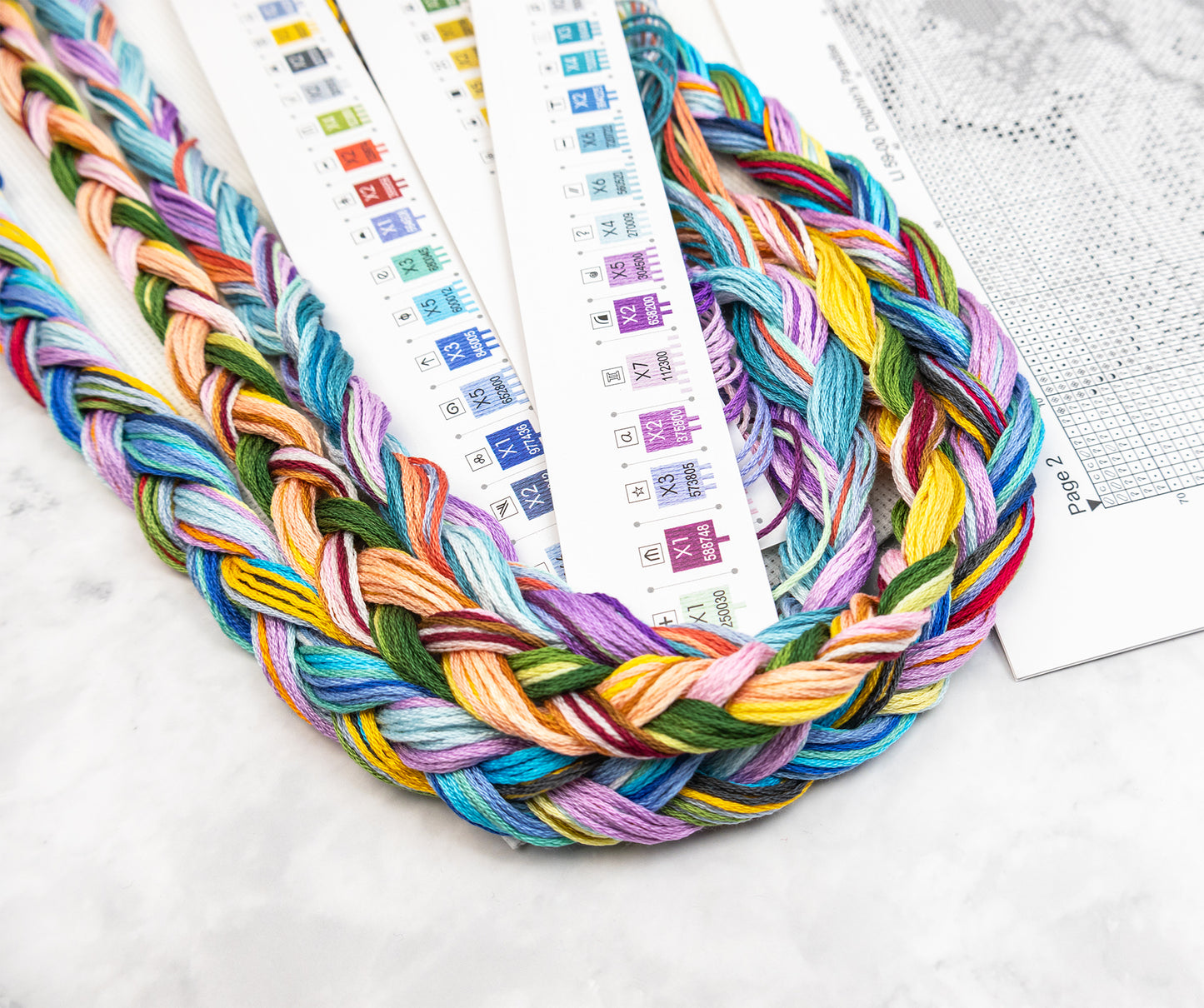 Colorful braided yarn on a white surface.