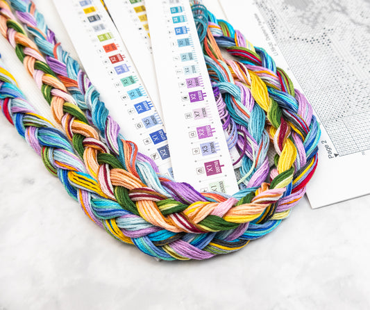 Colorful braided yarn on a white surface.