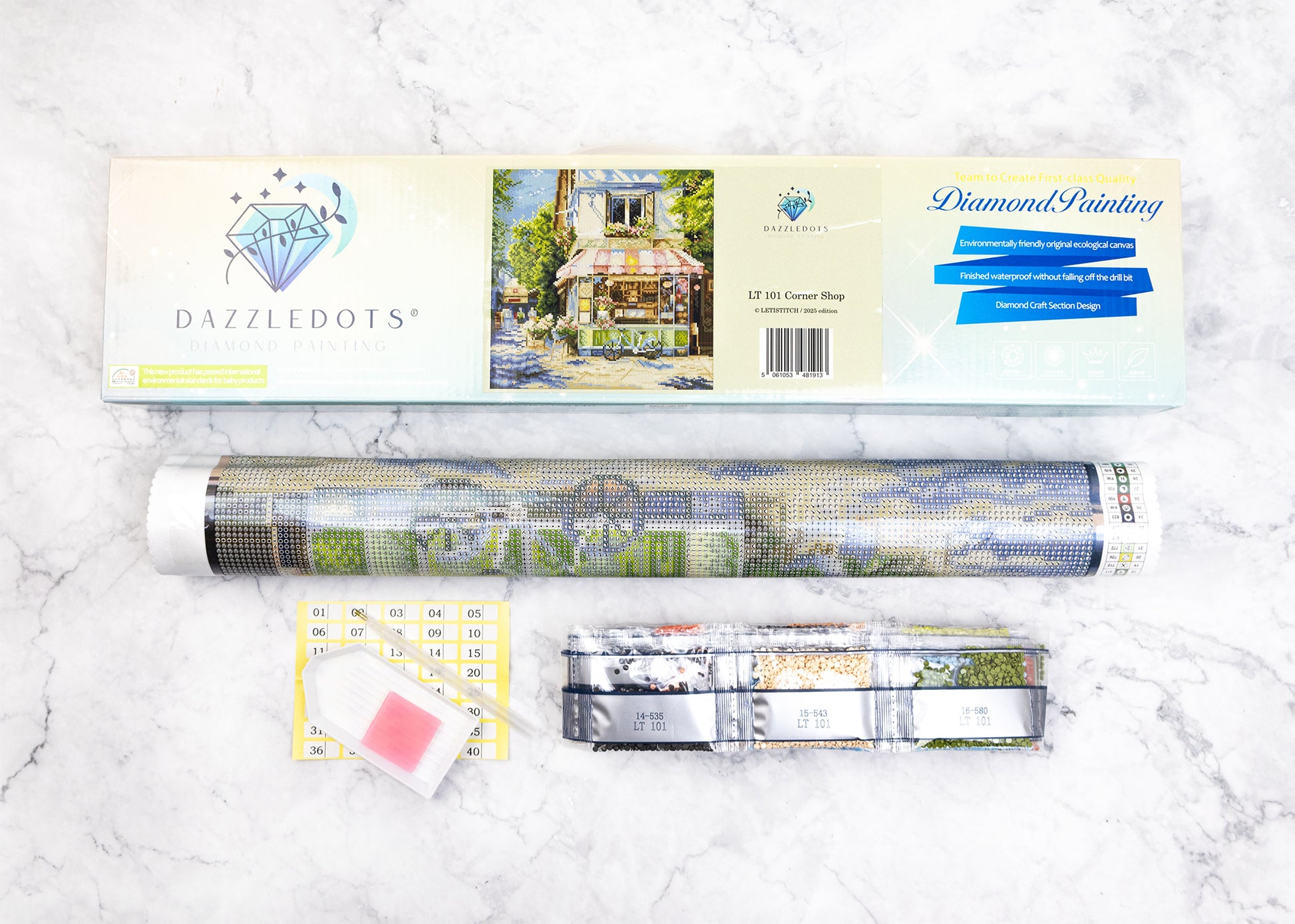 DAZZLEDOTS diamond painting kit on a marble surface