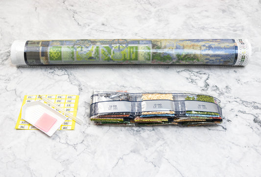 Diamond painting kit Dazzle Dots components on a marble surface