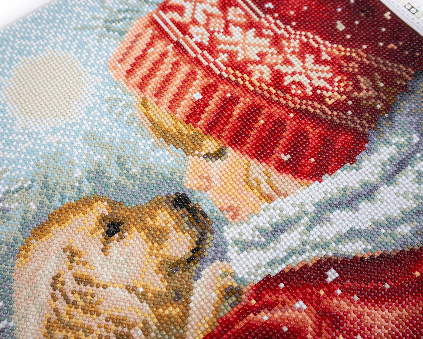 Close-up of a crystal art artwork depicting two dogs in winter clothing with snowflakes.