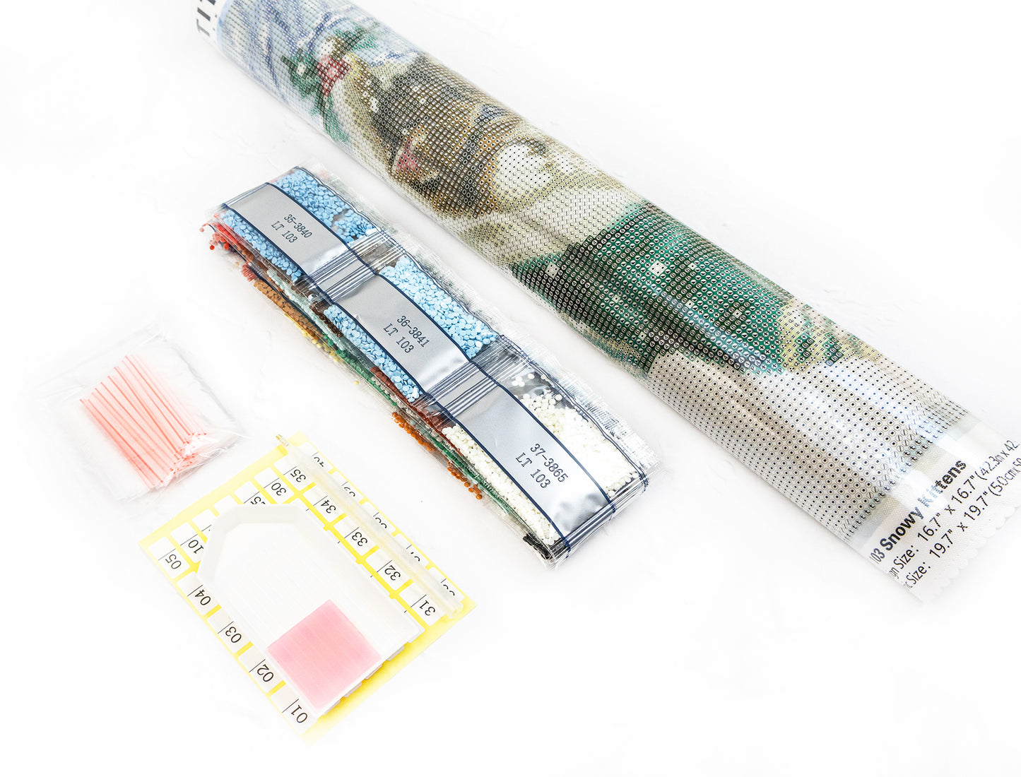 Diamond painting kit with a completed design, tools, and accessories on a white background