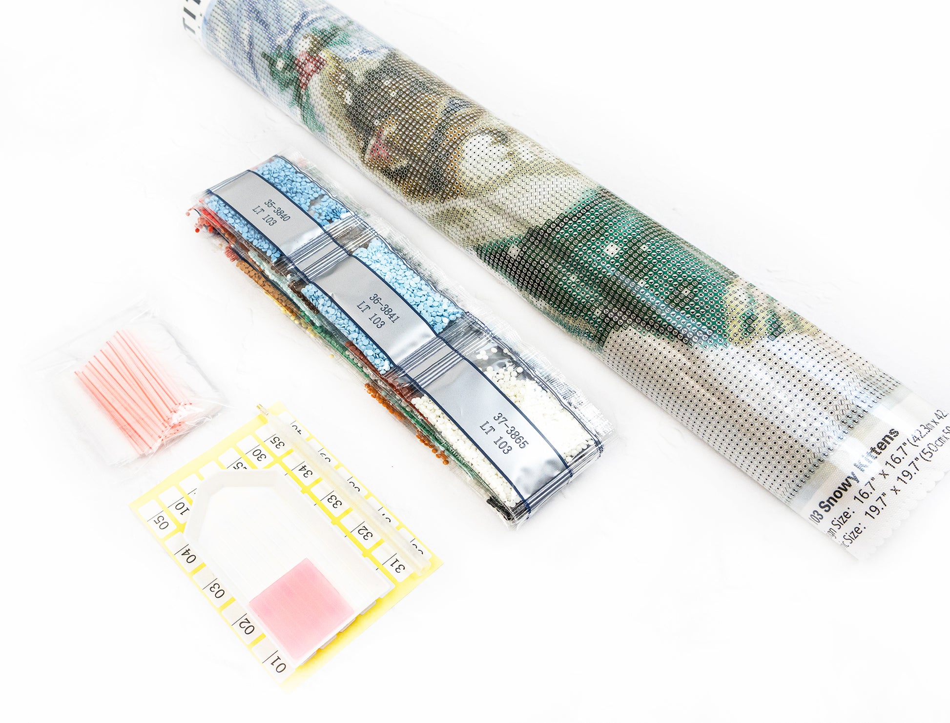 Diamond painting kit with a completed design, tools, and accessories on a white background