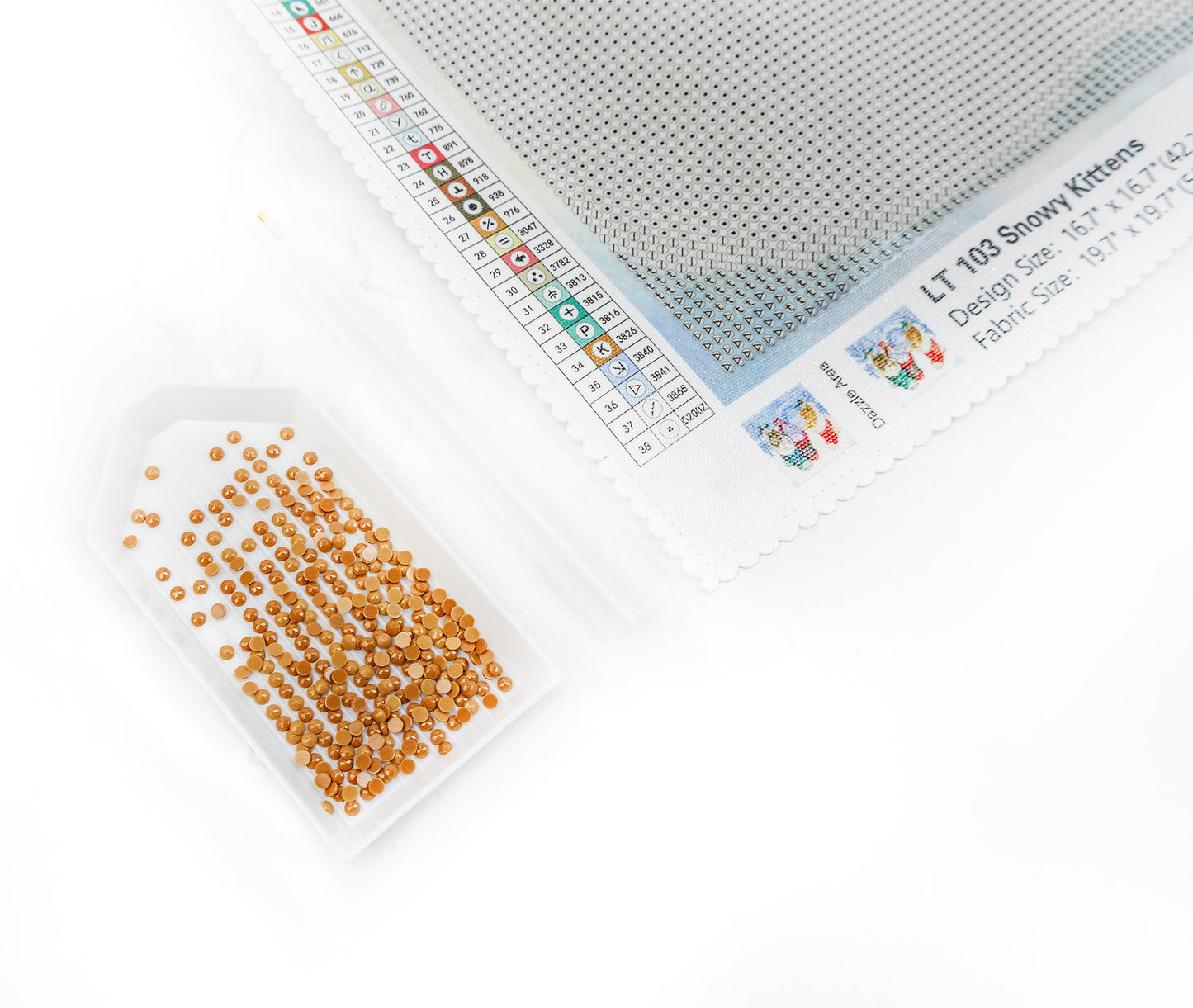 diamond art kit with fabric, thread, and pattern on a white background