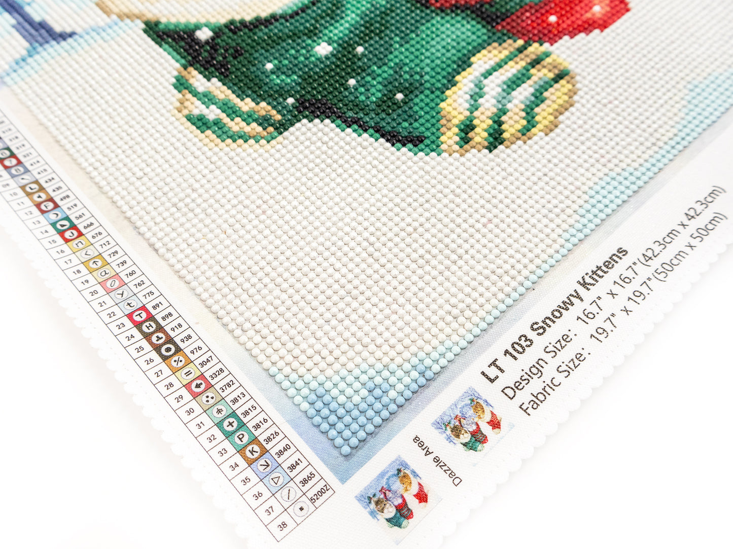 dazzle dots kit with a snowman design on fabric, ruler for measurement, and brand label.