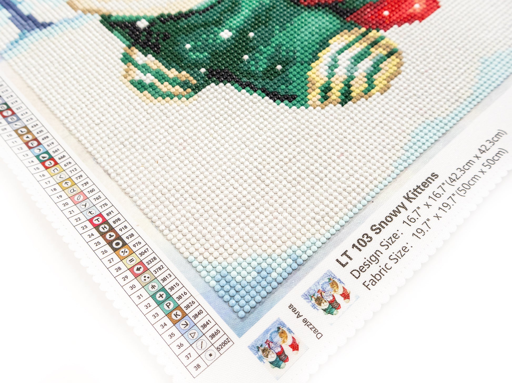 dazzle dots kit with a snowman design on fabric, ruler for measurement, and brand label.