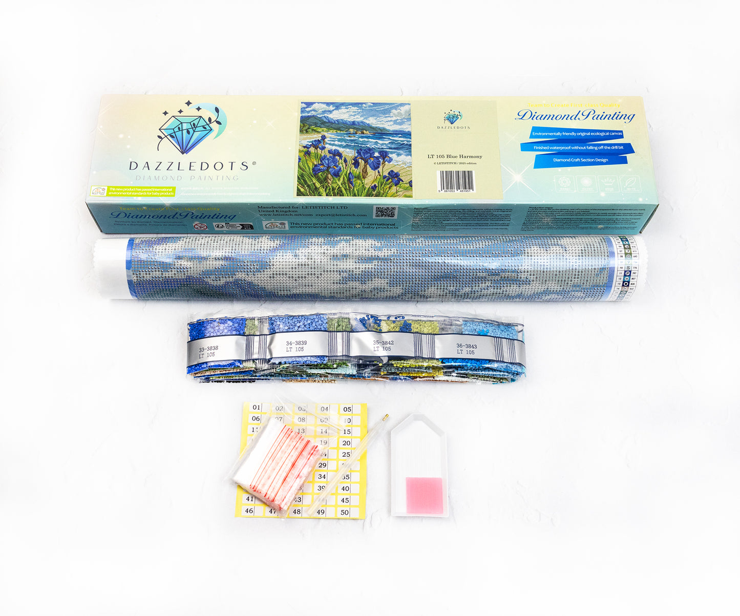 Diamond painting kit with roll of paper, blue thread, and packaging on a white background